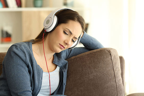 thoughtful women listening to headphones