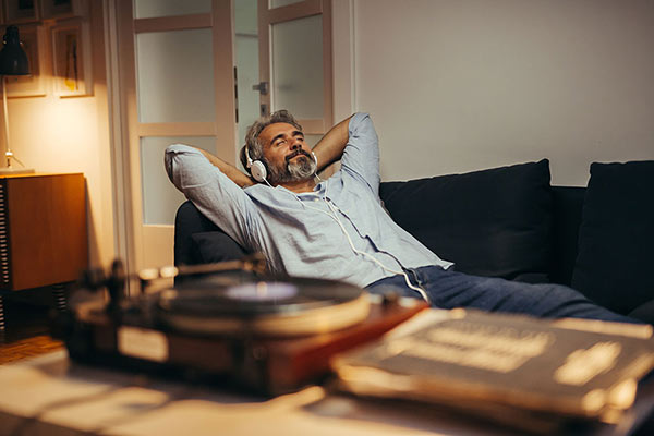 man listening to a record in an office
